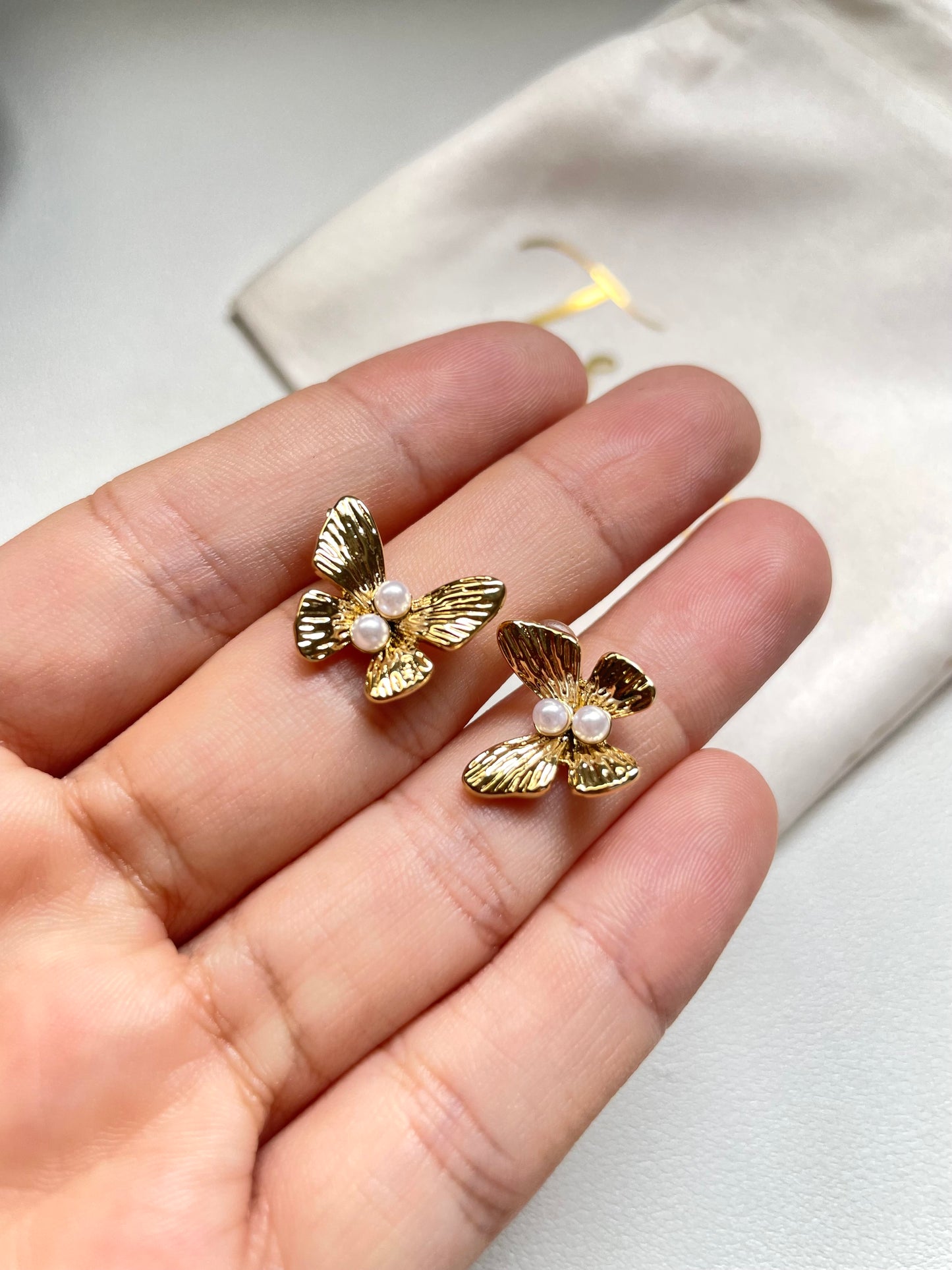 Butterfly and pearl earrings