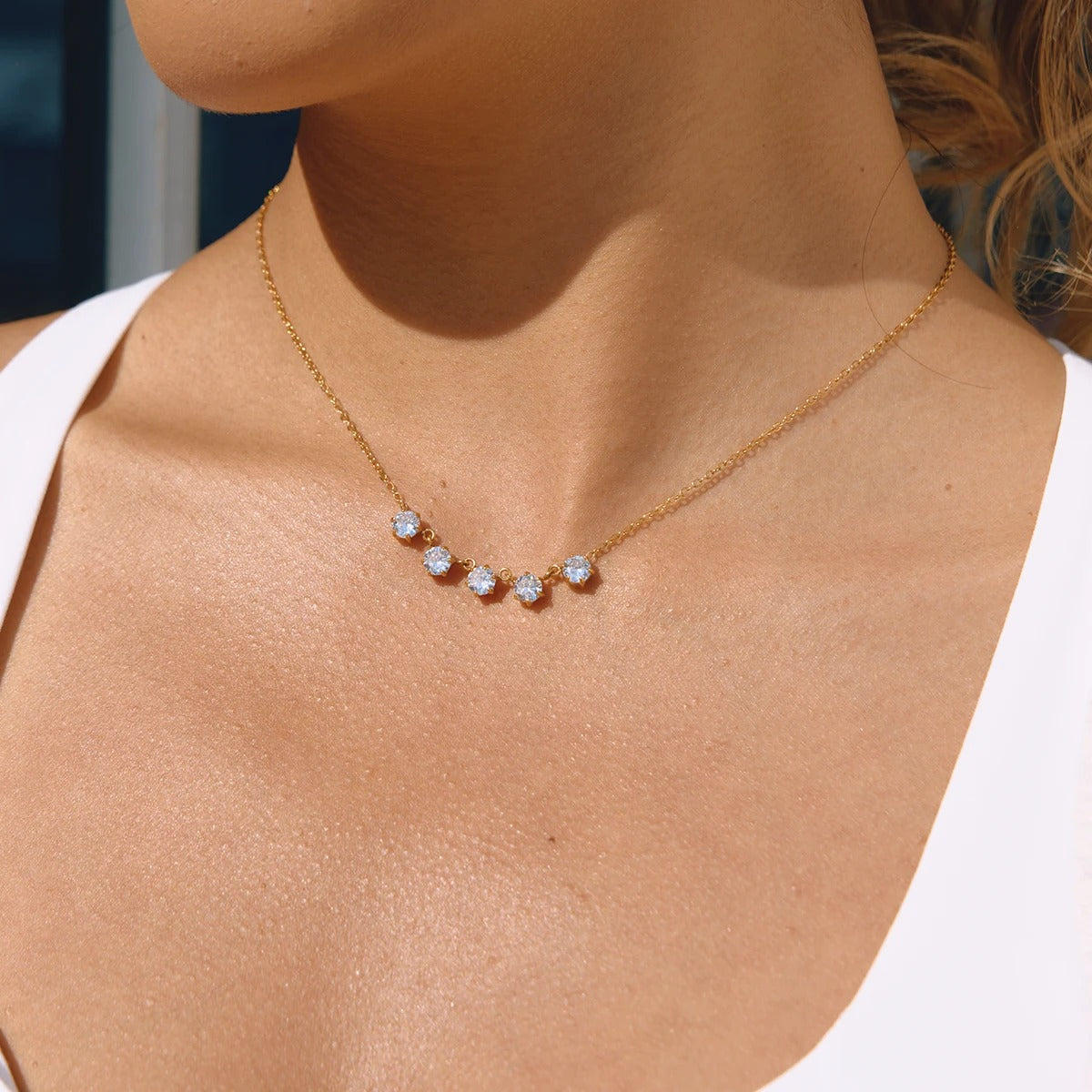 Delicate gold necklace with zircons